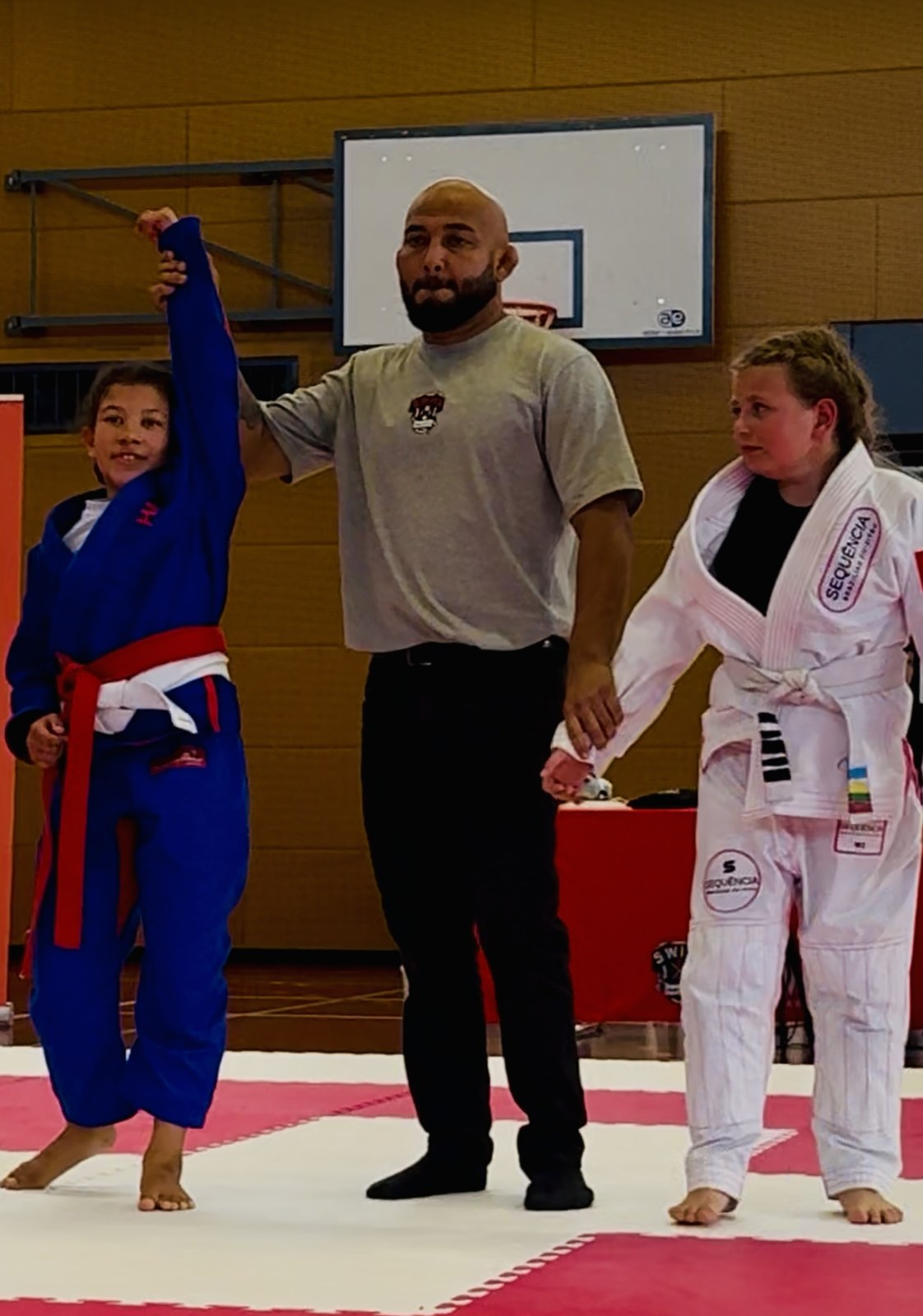 The referee raises her hand after a win.