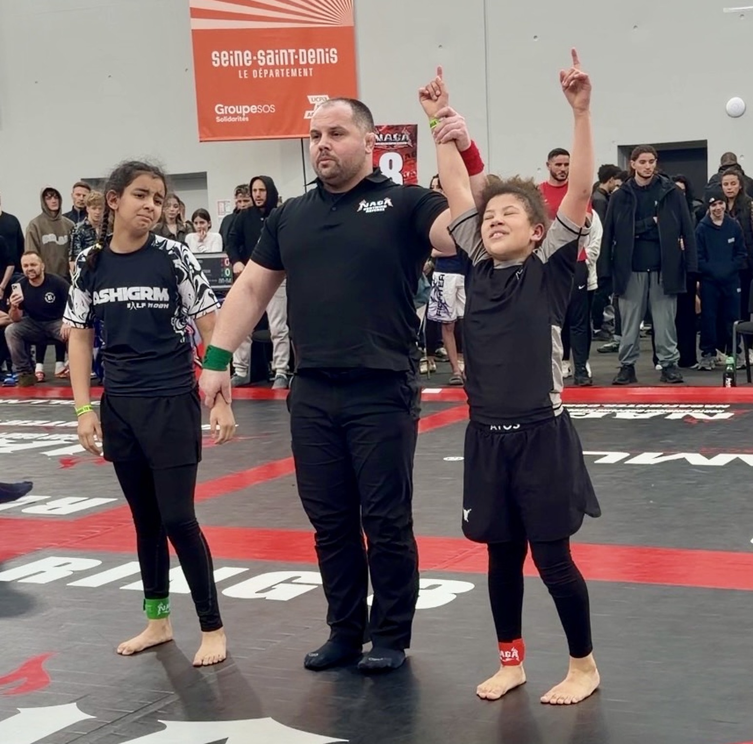 The referee raises her hand after a win at NAGA Paris, March 2026.